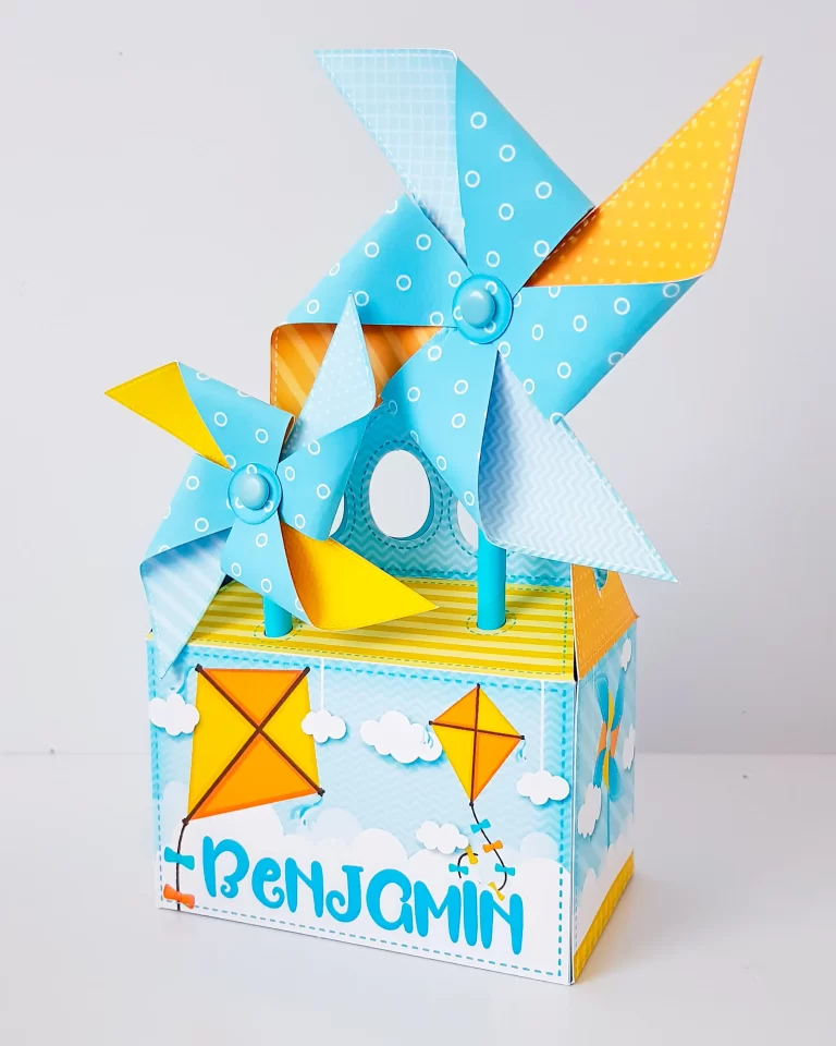 Topper de bolo com pipas e cataventos lúdicos em camadas tridimensionais com tons pastéis para decoração de festas.